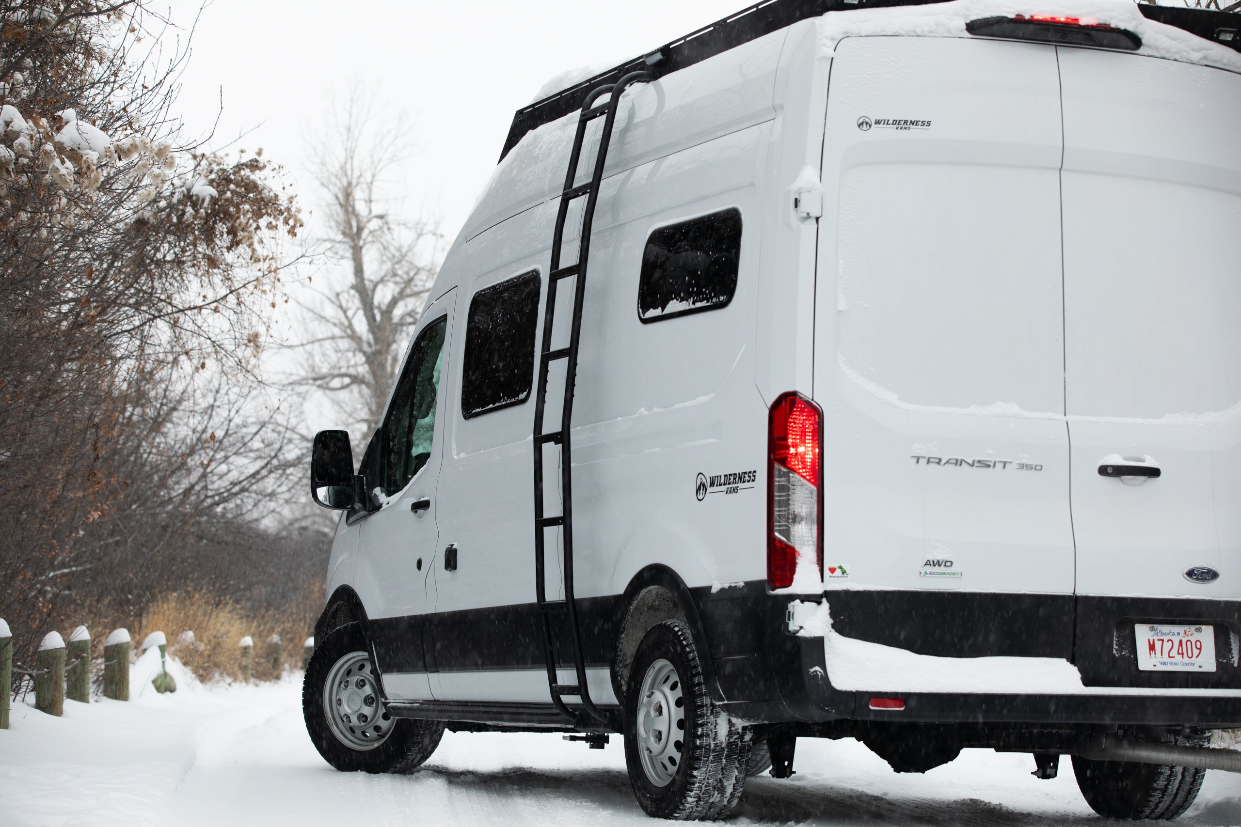 Ford transit with Orion roof rack and side ladder In the snow
