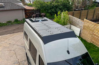 144 orion roof rack with deck panels configured around a rear ac