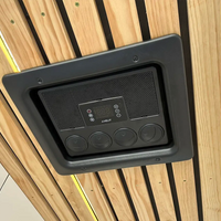Black electronic device mounted on a wooden panel