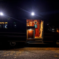 Transit Van with open door illuminated by senna 45 side lights on orion van gear roof rack