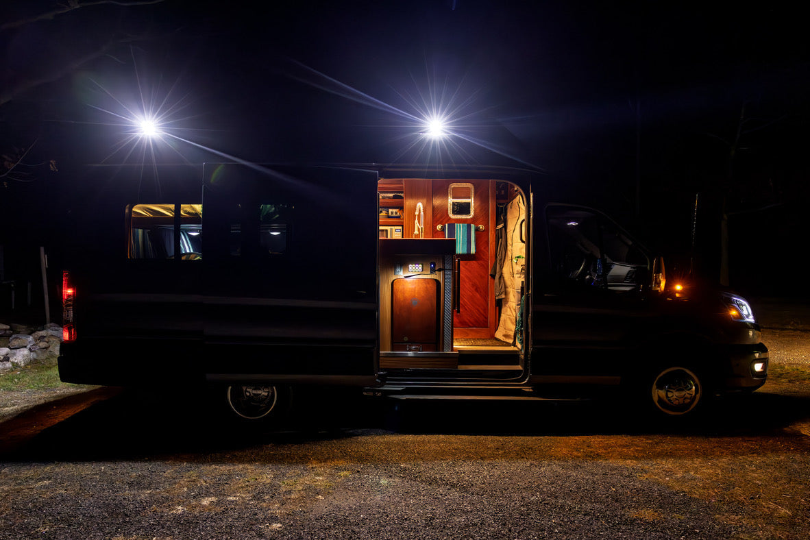 Transit Van with open door illuminated by senna 45 side lights on orion van gear roof rack