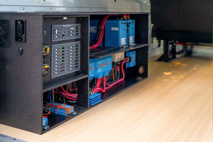 Driver side installed Artek pre-wired Victron power system in a Mercedes Sprinter