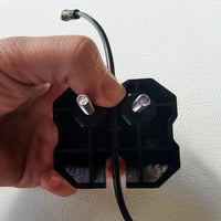 A hand holding a Diode Dynamics Stage Series Rack mount