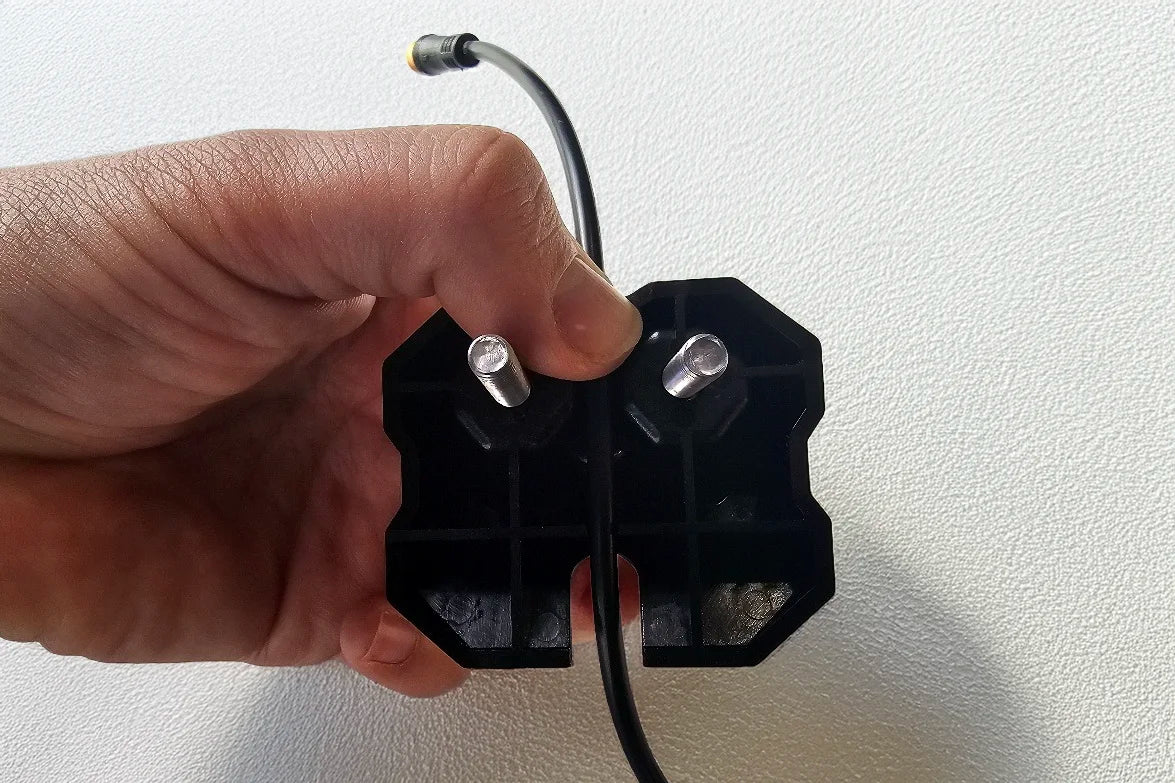 A hand holding a Diode Dynamics Stage Series Rack mount