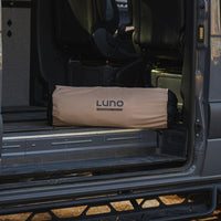 Van interior with a LUNO sleeping bag in the back seat