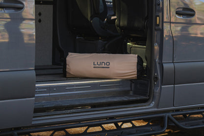 Van interior with a LUNO sleeping bag in the back seat