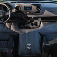 Interior of a vehicle with a T-shaped base extender for a flat sleeping surface.
