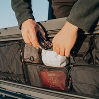 95L lid organizer - person putting headlamp into pocket