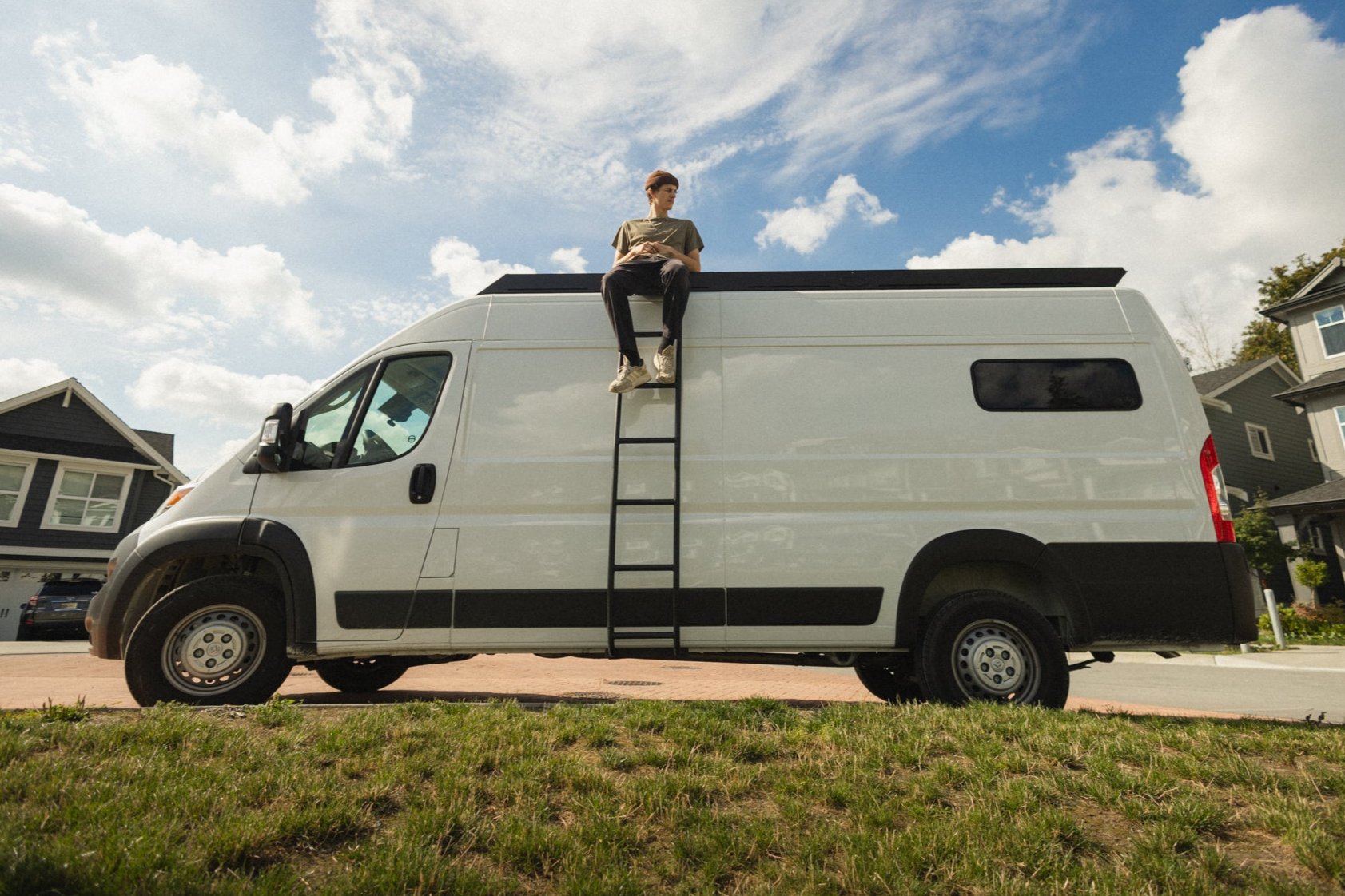 Ram Promaster roof rack with side ladder by Orion Van Gear, offering easy roof access and versatile storage for adventure-ready setups.