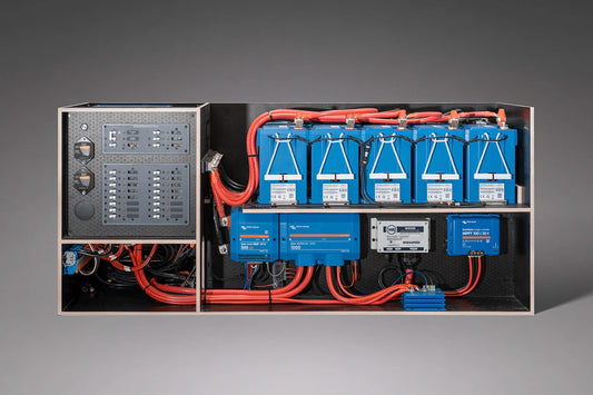 Electrical panel with blue batteries and red wiring on a gray background