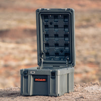 Roam 86L Case in an outdoor camping setup, placed on the ground