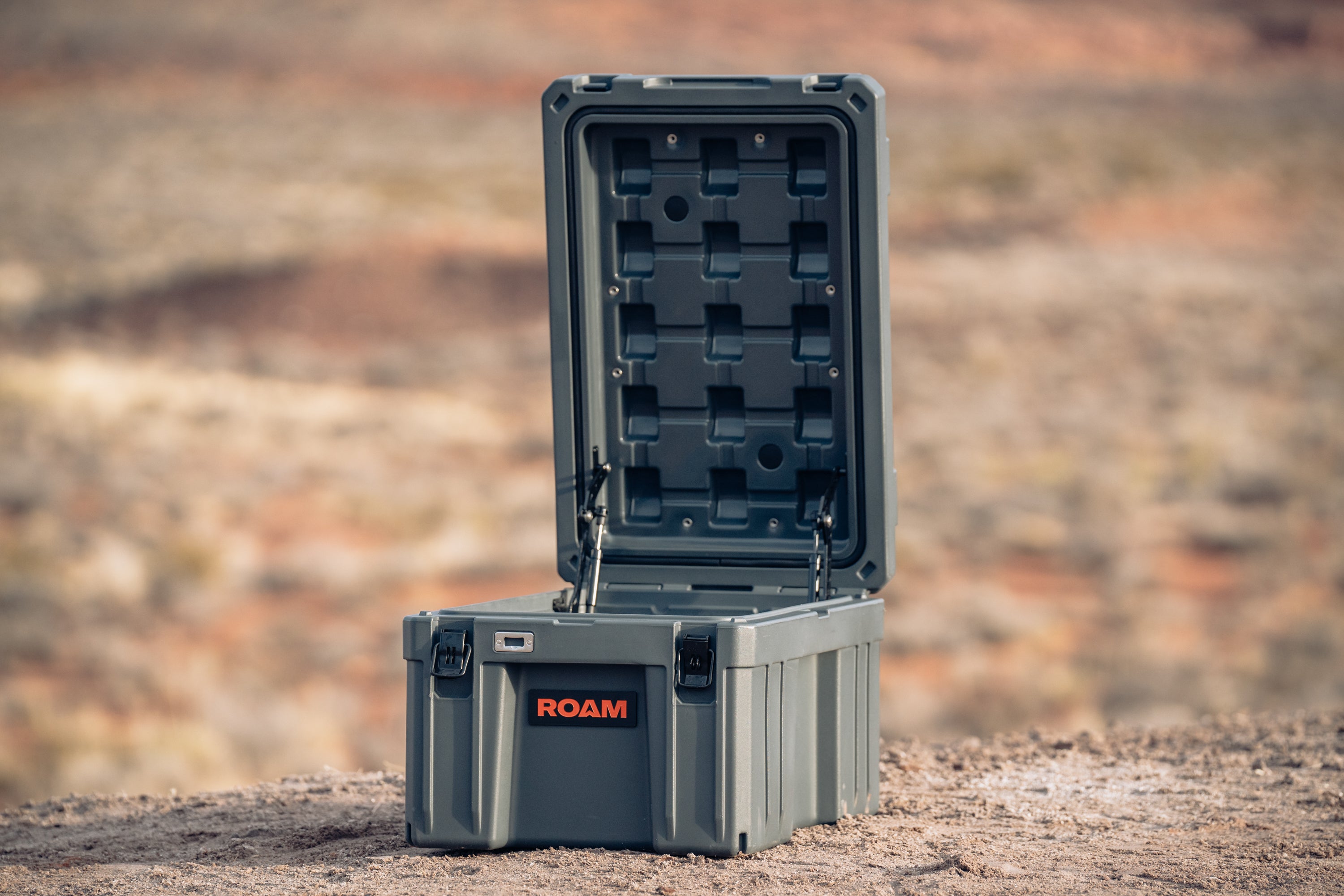 Roam 86L Case in an outdoor camping setup, placed on the ground