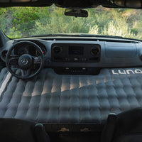 Inflatable mattress in the back of a vehicle with 'Luno' branding.
