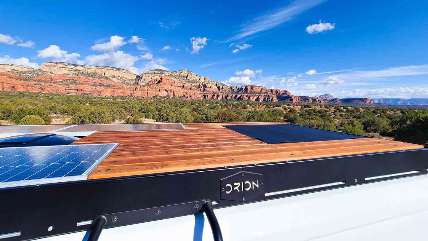 A promaster with orion stealth roof rack, flush solar, and decking in sedona 