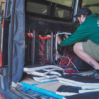 Person installing thinsulate on a van
