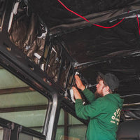 Person working on the interior of a van installing 3m thinsulate insulation