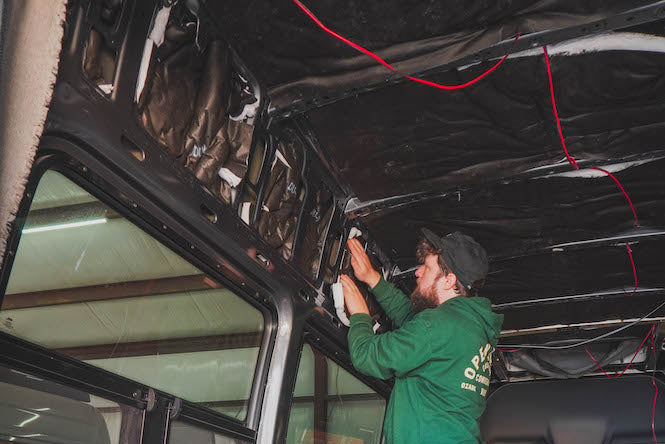 Person working on the interior of a van installing 3m thinsulate insulation