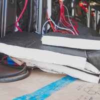 Stack of 3m thinsulate insulation materials with electrical wiring in the background
