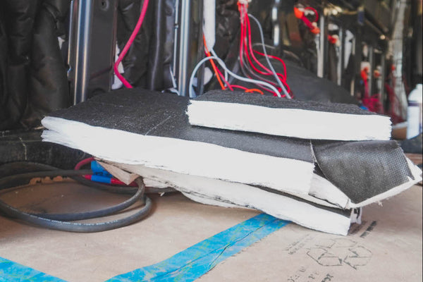 Stack of 3m thinsulate insulation materials with electrical wiring in the background