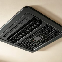 A black ceiling-mounted velit V3 air conditioner with a digital display and control buttons, installed on a beige ceiling.