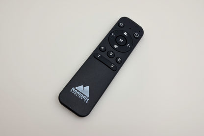 Black remote control with Nomadic Gaming Co logo on a white background