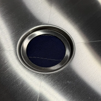 Close-up of stainless steel van shower pan drain area