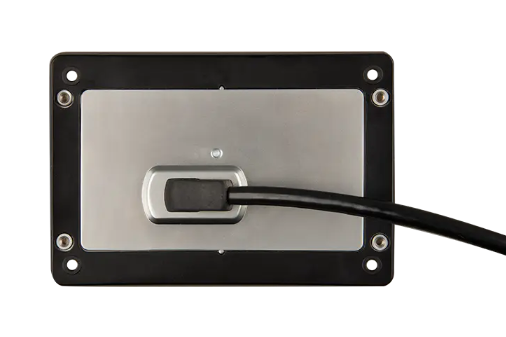Metallic panel with a black cable plugged into it on a white background