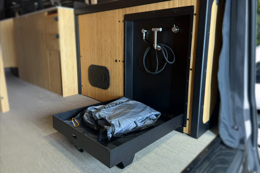 Tetravan folding shower showing stainless fixtures, drain, latch, and black finish