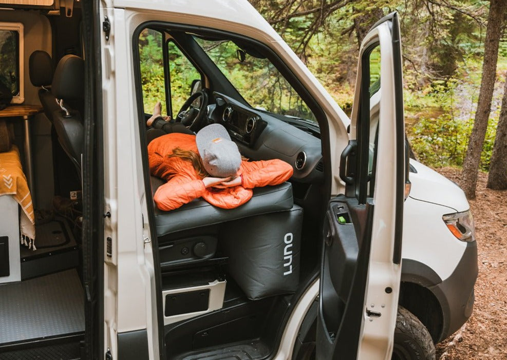 Woman laying on Luno Van Front Cab Air Mattress in a Sprinter