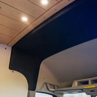 Ford Transit High Roof front trim installed, bulkhead transition close-up - black