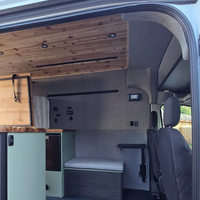 Interior of a van with wooden ceiling and seating area with go code trim kit upholstered