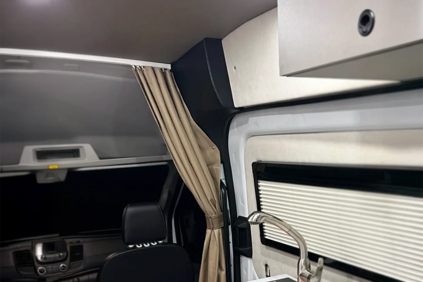Interior of a vehicle with a curtain and window blinds - go code front pillar 