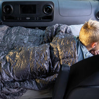 Child lying on a car seat cover in a vehicle with text 'Great for kids, small adults, & pets.'