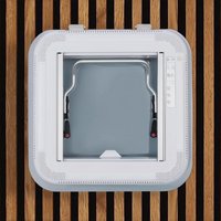 Interior view of the NomadicArk 450 x 400 van and RV skylight showing LED lights, handles, blind, and bug screen installed on wood slats on van ceiling 