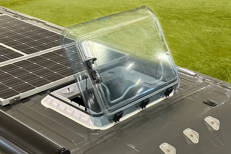 Top down view of a NomadicArk 700 x 500mm van and RV skylight with bug screen and shade shown on a van roof