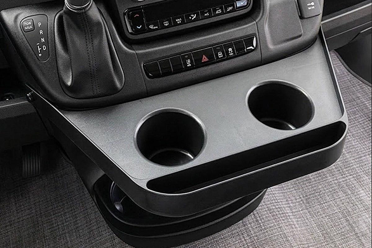 Ram Promaster dashboard with a console, cup holders, and a touchscreen display.