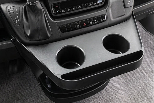 Ram Promaster dashboard with a console, cup holders, and a touchscreen display.