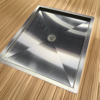 Recessed stainless steel shower pan installed in a van floor