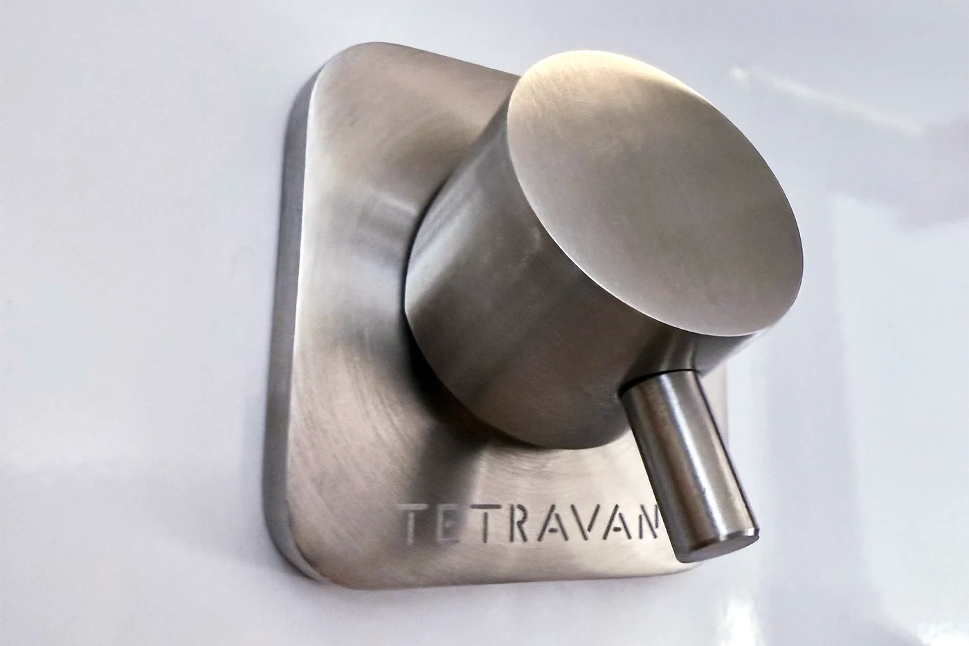 Metallic shower handle with 'Tetravan' branding on a white background