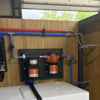 Mechanical setup with pipes and components inside a vehicle or trailer.
