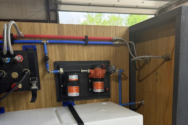 Mechanical setup with pipes and components inside a vehicle or trailer.