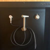 Stainless steel plumbing fixtures on the Tetravan Folding Shower 2.1
