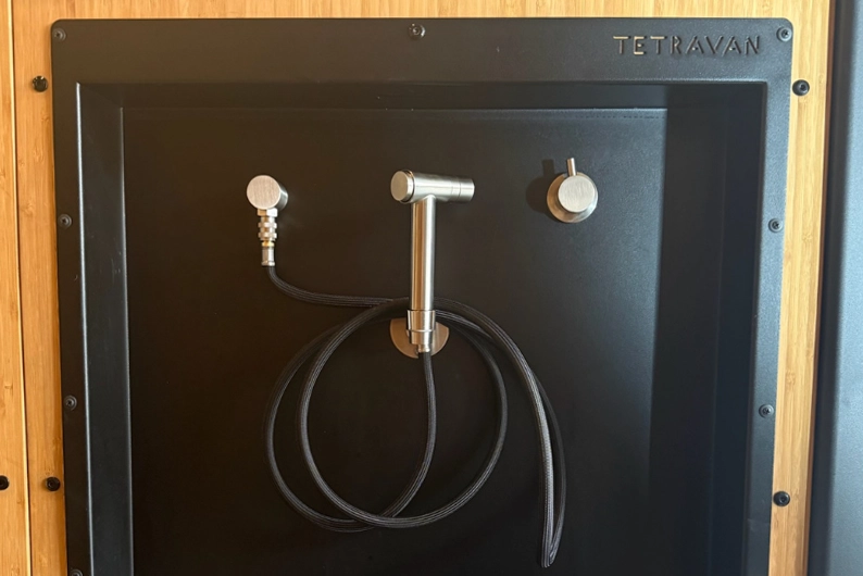 Stainless steel plumbing fixtures on the Tetravan Folding Shower 2.1