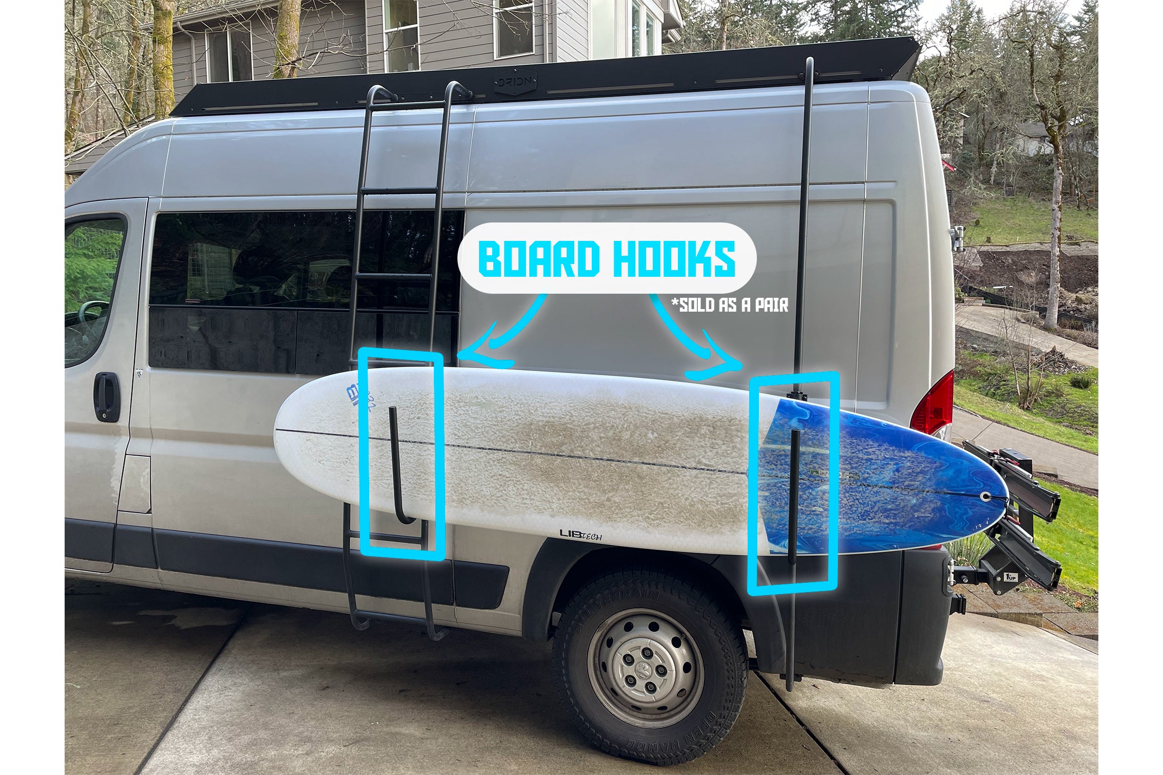 A surf board on the side of a van using Orion van gear products