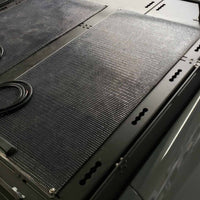 150 watt panel with black backing on orion roof rack with modular deck panels
