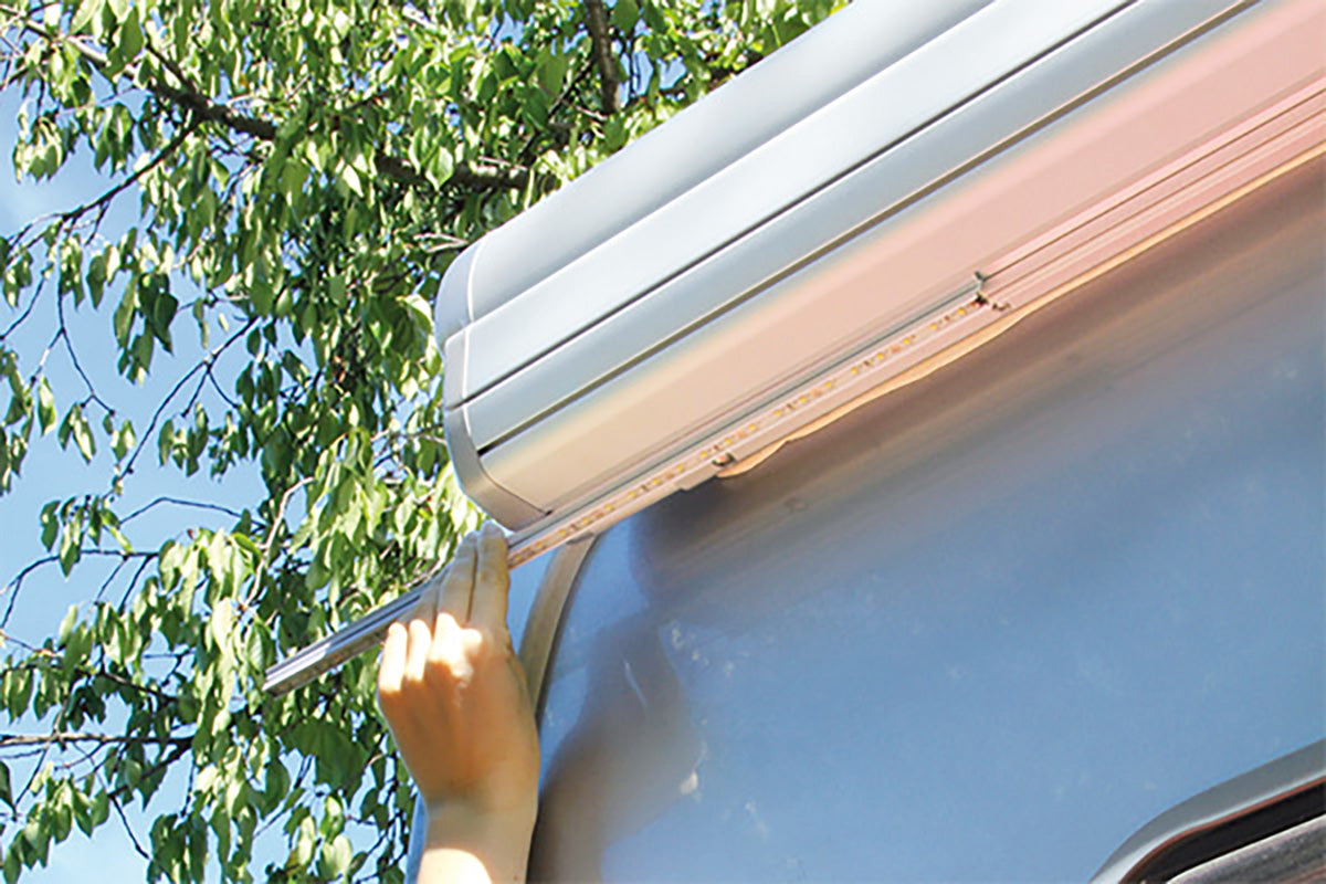Fiamma LED strip being slid into Fiamma awning